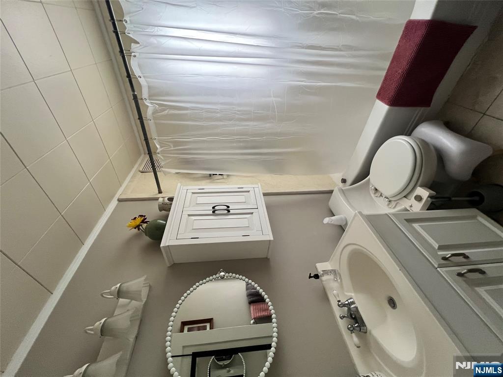 157 Harrington Road Clifton, NJ 07012 - Photo 2 of 9 a bathroom with a sink toilet and shower