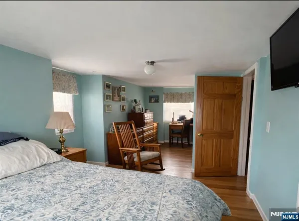 a bedroom with furniture and a flat screen tv
