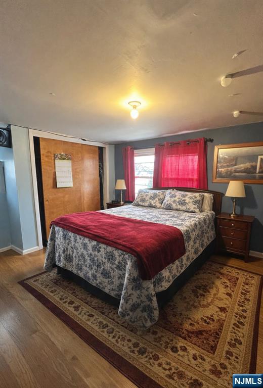 157 Harrington Road Clifton, NJ 07012 - Photo 6 of 9 a bed sitting in a bedroom next to a window