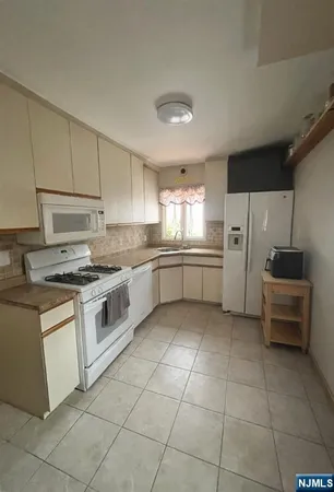 a kitchen with a stove sink and a refrigerator