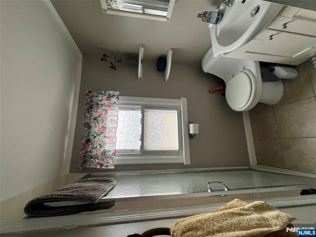 157 Harrington Road Clifton, NJ 07012 - Photo 9 of 9 a bathroom with a toilet sink and mirror