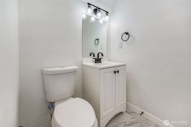 a white toilet sitting next to a bathroom sink