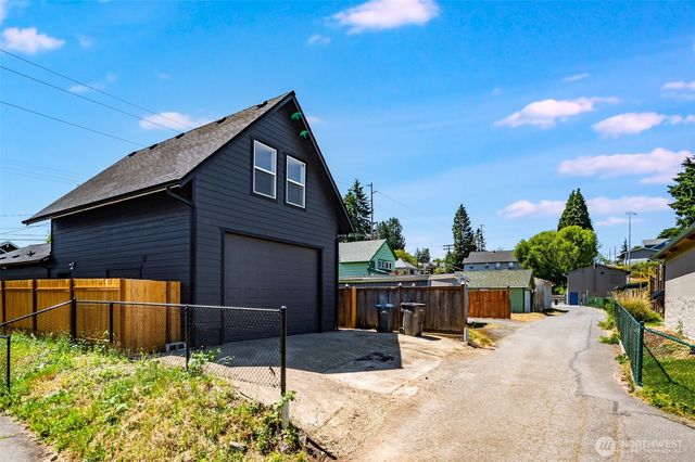 a view of a house with wooden fence