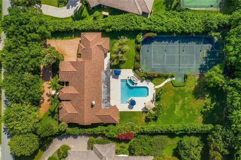 an aerial view of a house with a yard