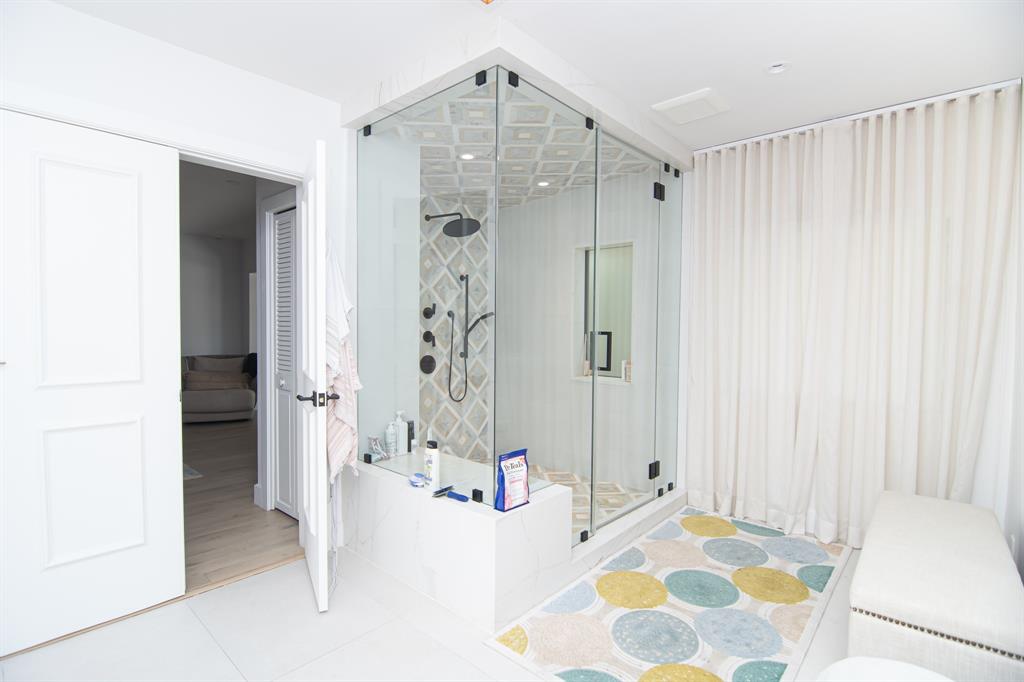 8208 Twin Lake Drive Boca Raton, FL 33496 - Photo 11 of 53 a spacious bathroom with a bathtub and a shower