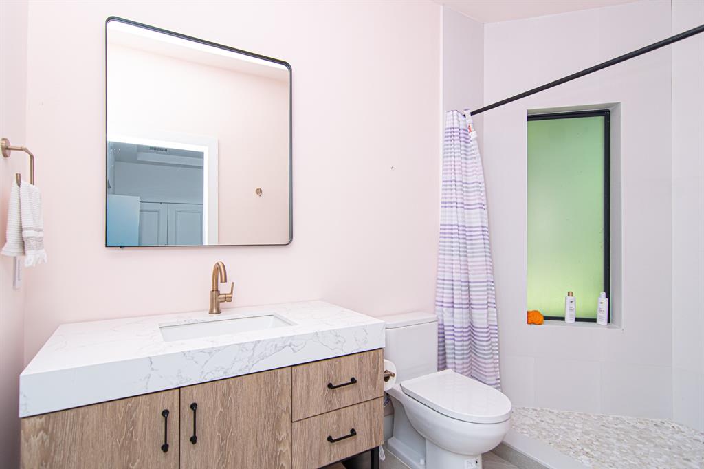 8208 Twin Lake Drive Boca Raton, FL 33496 - Photo 27 of 53 a bathroom with a toilet a sink and a mirror