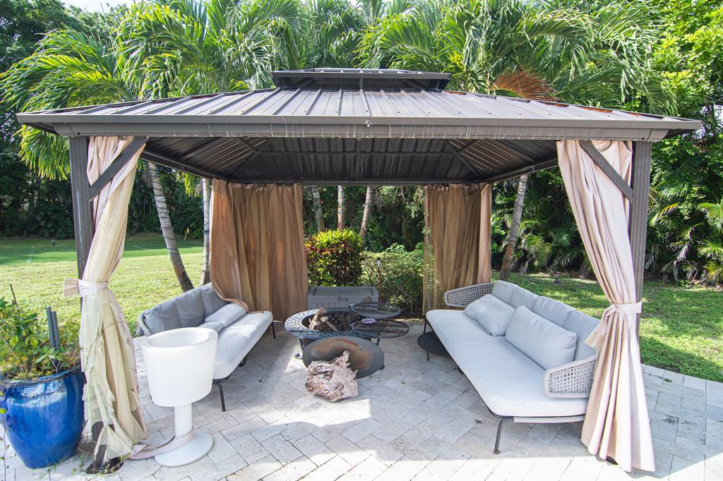 8208 Twin Lake Drive Boca Raton, FL 33496 - Photo 34 of 53 a patio with lawn chairs and potted plants