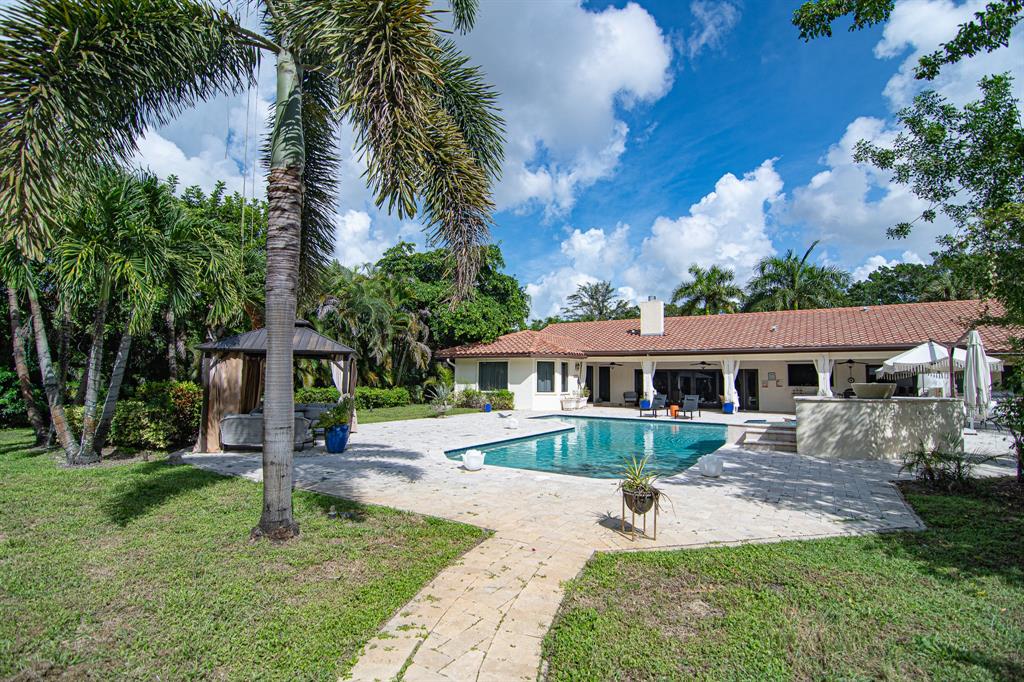 8208 Twin Lake Drive Boca Raton, FL 33496 - Photo 38 of 53 front view of a house with a yard