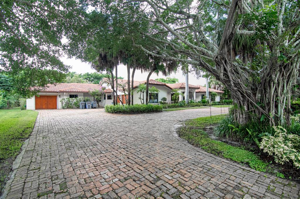8208 Twin Lake Drive Boca Raton, FL 33496 - Photo 48 of 53 a front view of a house with a yard
