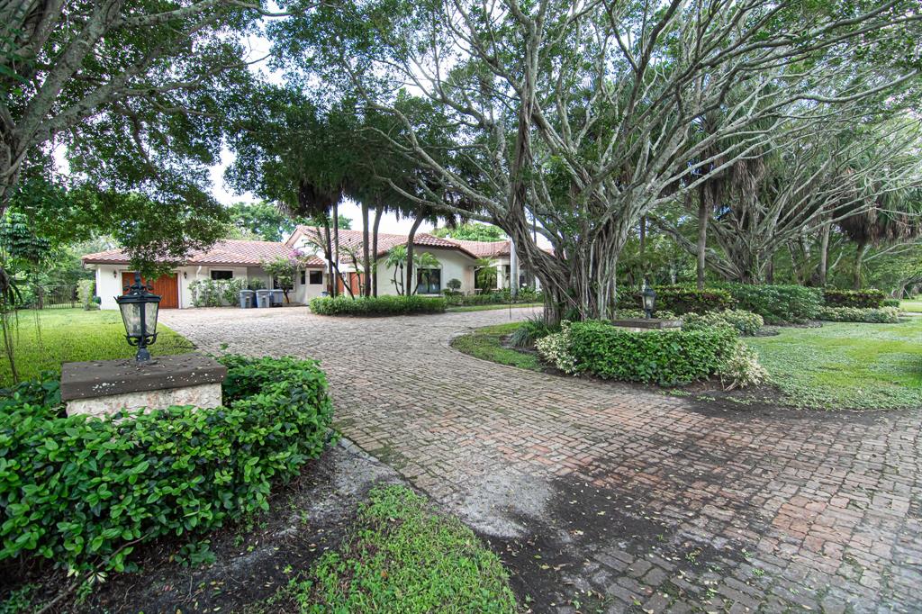 8208 Twin Lake Drive Boca Raton, FL 33496 - Photo 49 of 53 a front view of a house with a yard