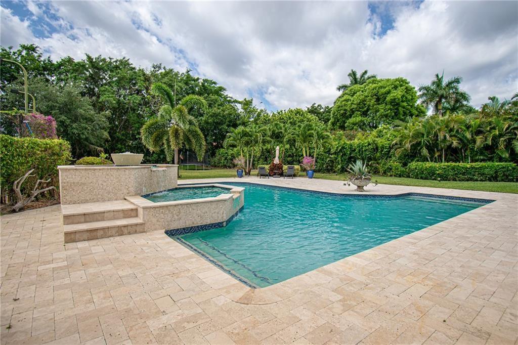 8208 Twin Lake Drive Boca Raton, FL 33496 - Photo 51 of 53 a view of a swimming pool with a yard