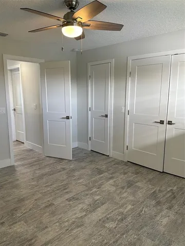 a view of house with a big yard and potted plants