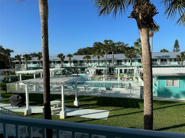 a view of a patio with couches table and chairs and potted plants