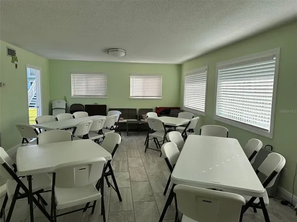 a black white refrigerator freezer sitting inside of a kitchen