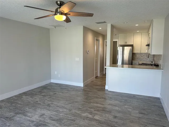 a kitchen with stainless steel appliances granite countertop a stove a refrigerator and a sink