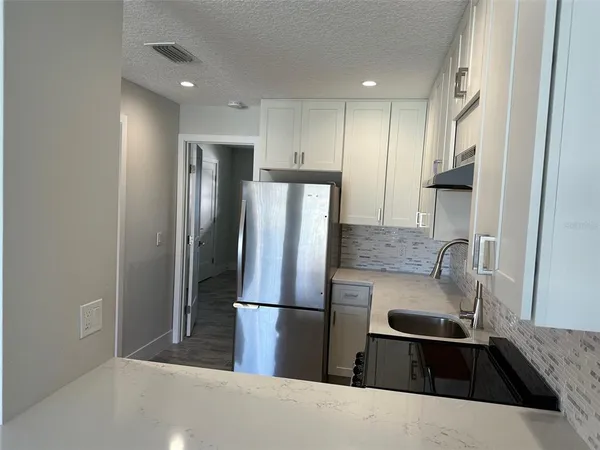 a bathroom with a double vanity sink and a toilet