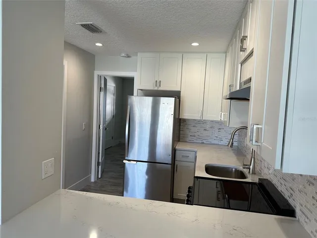a bathroom with a double vanity sink and a toilet