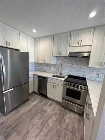 a bathroom with a granite countertop toilet sink and shower