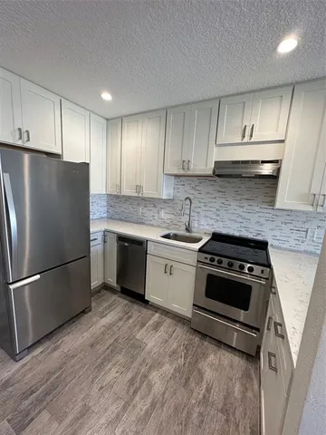 a bathroom with a granite countertop toilet sink and shower