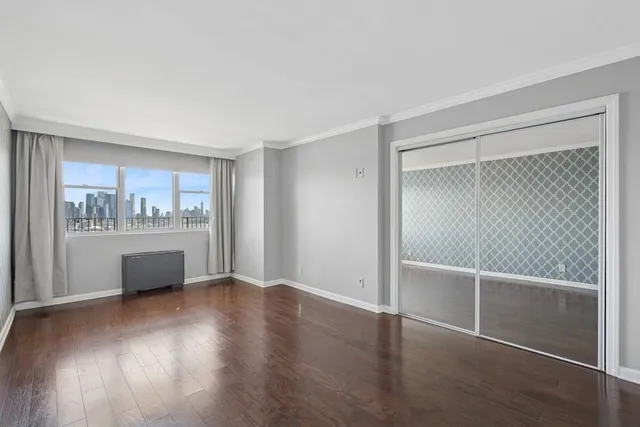 an empty room with a fireplace and a window