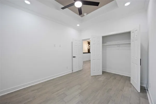 an empty room with a empty space and chandelier fan
