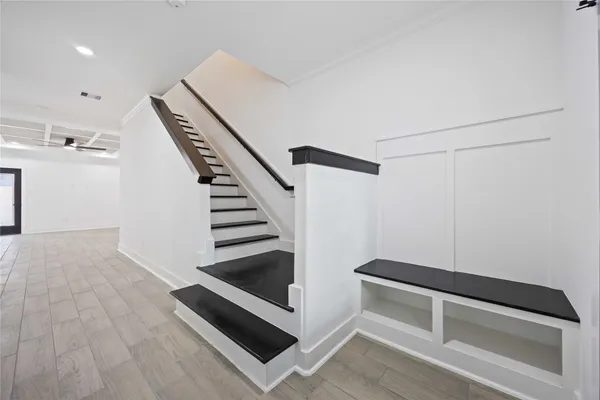 a view of entryway and hall with wooden floor