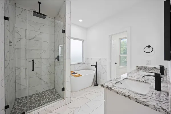 a spacious bathroom with a granite countertop sink a toilet and shower