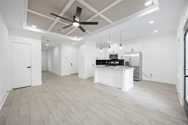 a view of kitchen with stainless steel appliances refrigerator stove microwave and cabinets