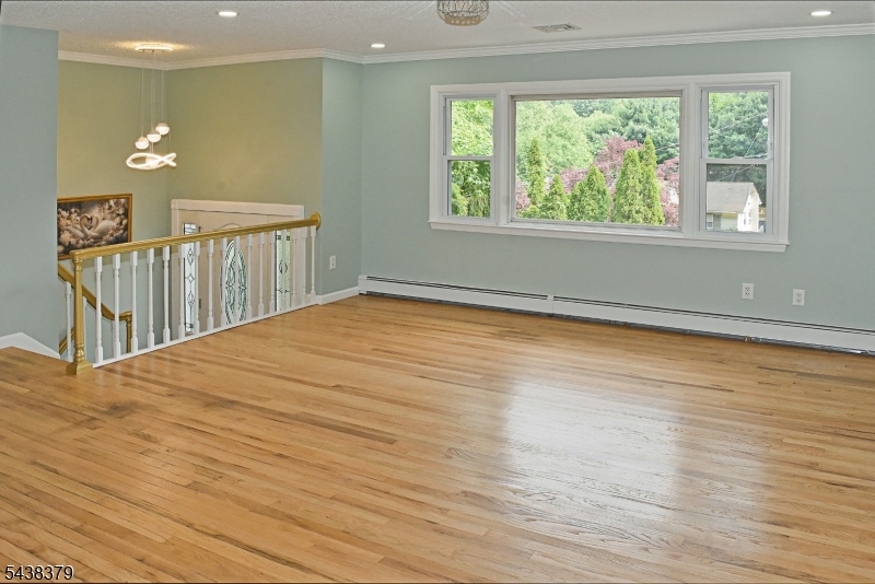 504 Edith Road Landing, NJ 07850 - Photo 9 of 28 a view of an empty room with wooden floor and a window