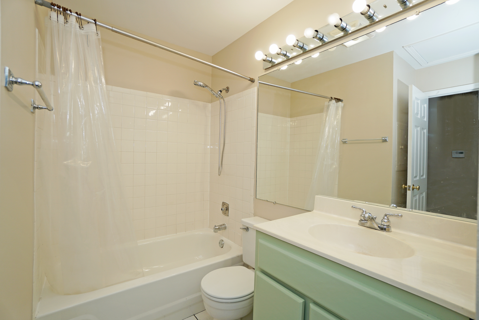 1217 Ranchview Court Buffalo Grove, IL 60089 - Photo 12 of 16 a bathroom with a granite countertop sink a toilet and shower