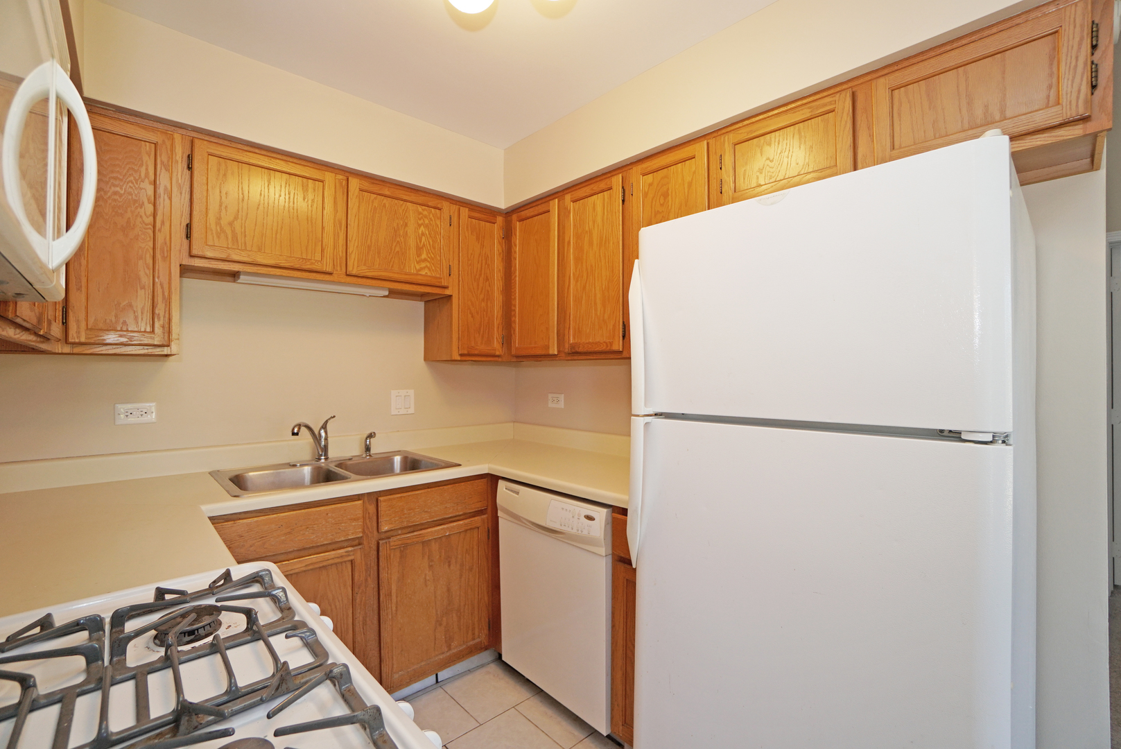 1217 Ranchview Court Buffalo Grove, IL 60089 - Photo 8 of 16 a white refrigerator freezer sitting inside of a kitchen