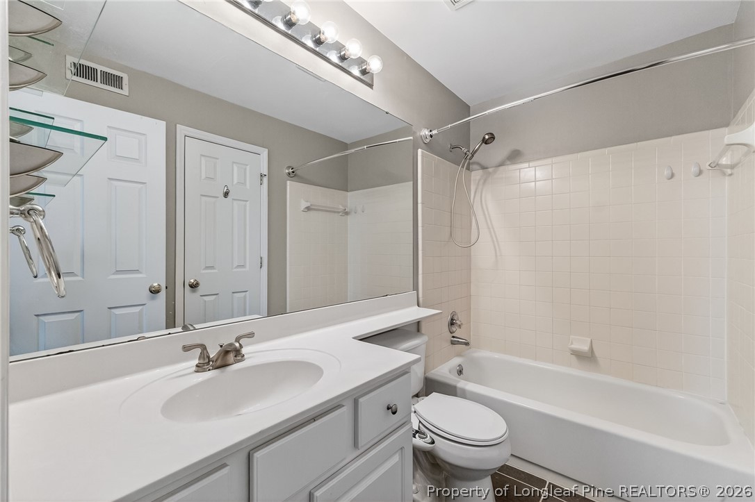 1221 Westview Lane, Unit 301 Raleigh, NC 27605 - Photo 20 of 32 a bathroom with a sink a toilet and a large mirror