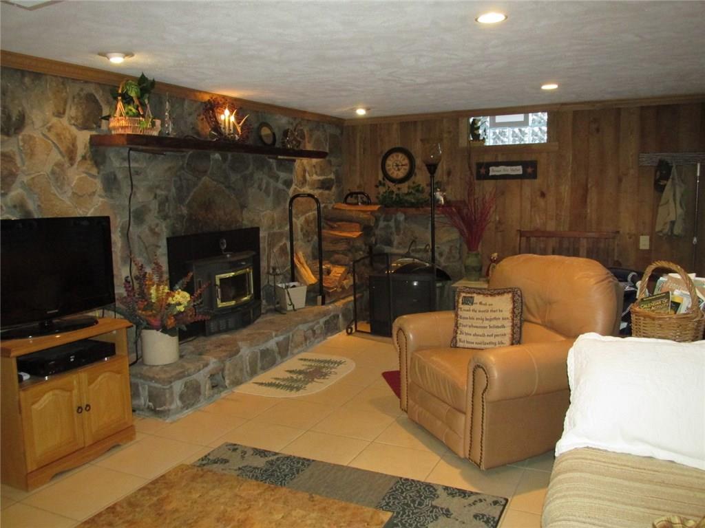 392 Maple Summit Road Mill Run, PA 15464 - Photo 15 of 25 Another stone wall and the third wood burner! This is one long rectangular room!