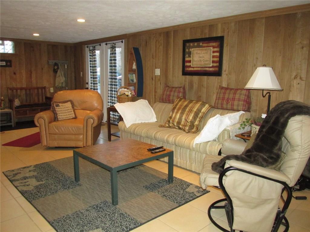 392 Maple Summit Road Mill Run, PA 15464 - Photo 16 of 25 Those wood walls are sassafras and stunning! Outside of the back window door is the parking area. This room is great if you have bad knees!