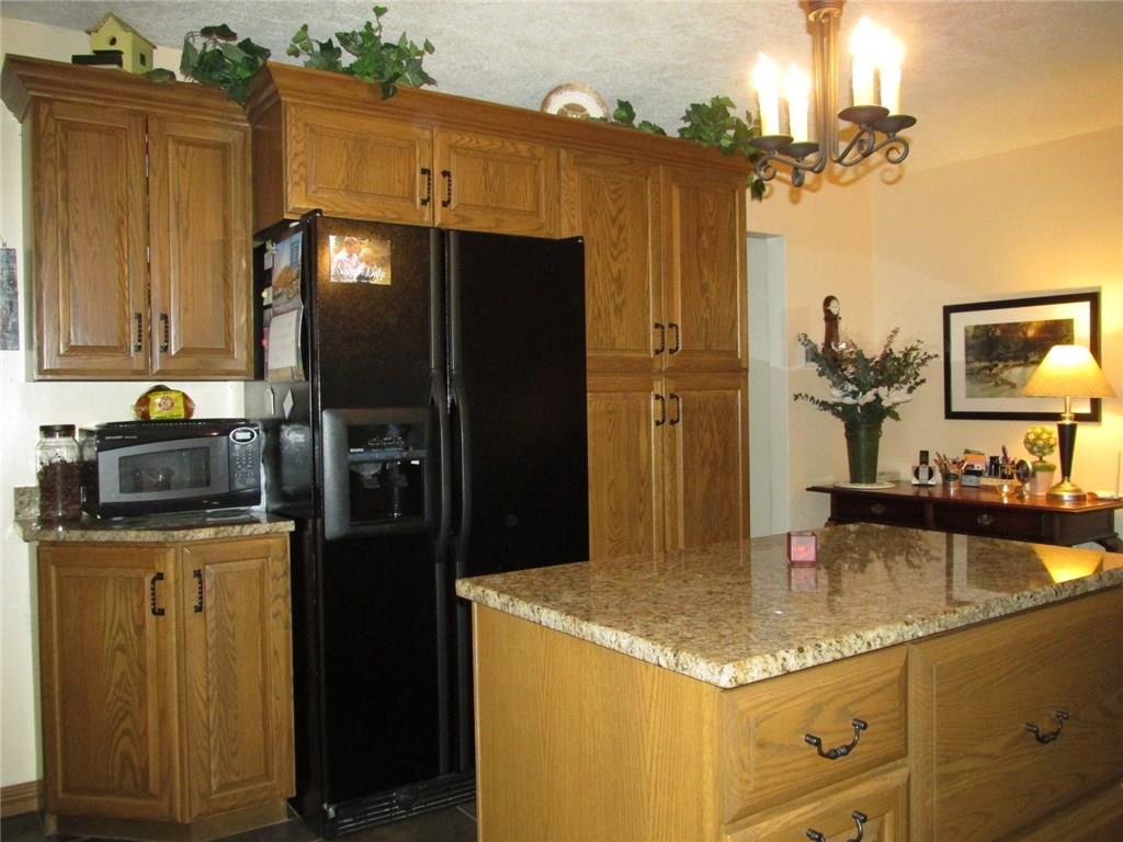 392 Maple Summit Road Mill Run, PA 15464 - Photo 4 of 25 Here's the kitchen island with storage. On the back wall is a double door fridge with water and ice. The microwave is the left.