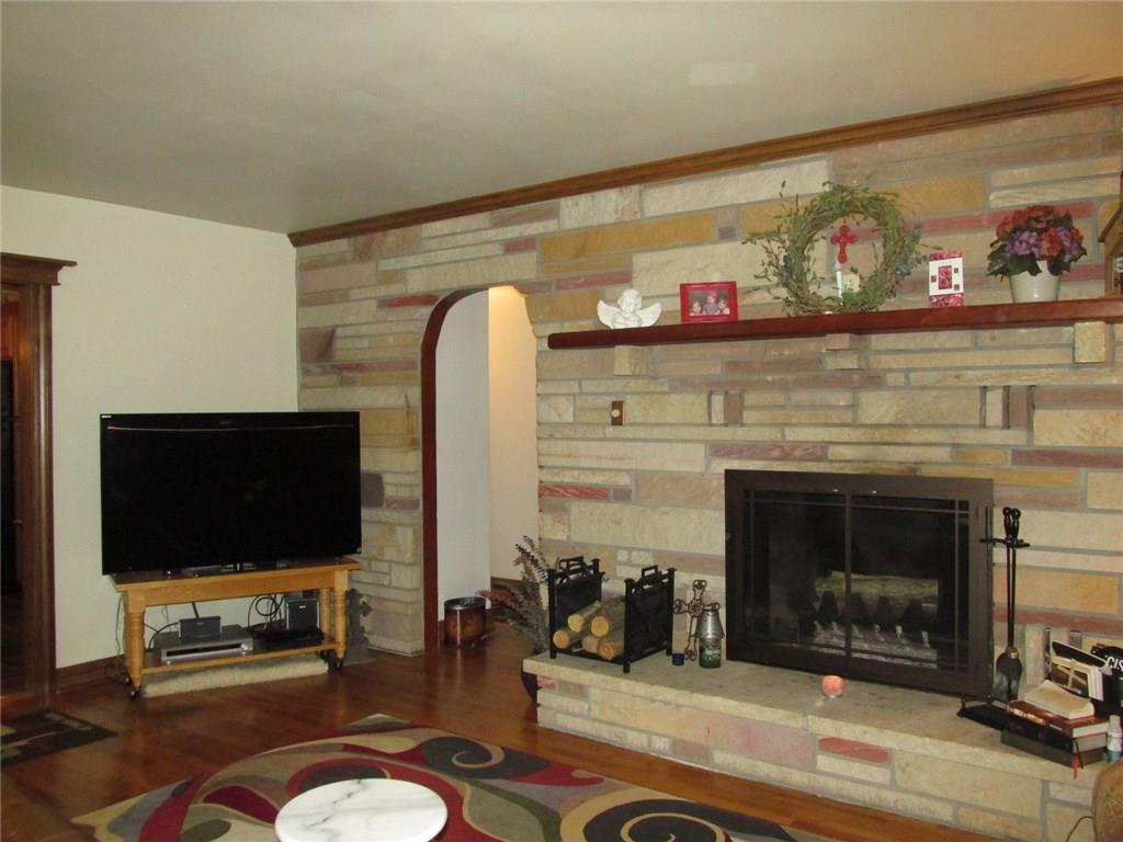 392 Maple Summit Road Mill Run, PA 15464 - Photo 9 of 25 Here's the other side! How about that hearth! To the left is the pass through to the kitchen. Through the archway are the two bedrooms. Let's check out the master bedroom first.