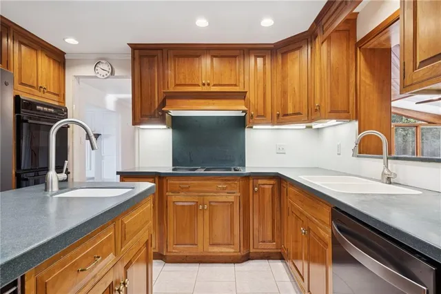 a kitchen with granite countertop a sink and cabinets