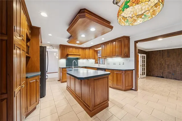 a kitchen with stainless steel appliances granite countertop a sink and a stove