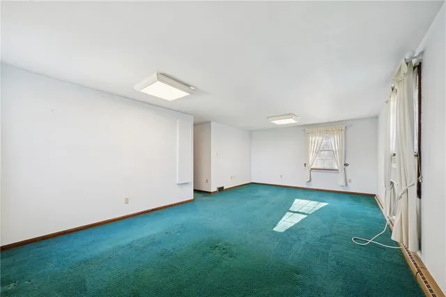 an empty room with closet and windows