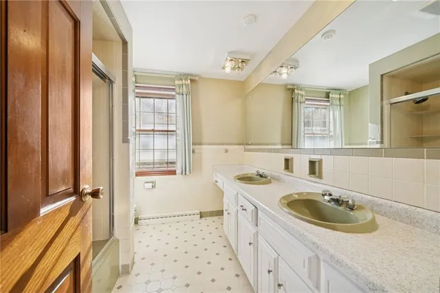 a bathroom with a sink a vanity a mirror and a bathtub