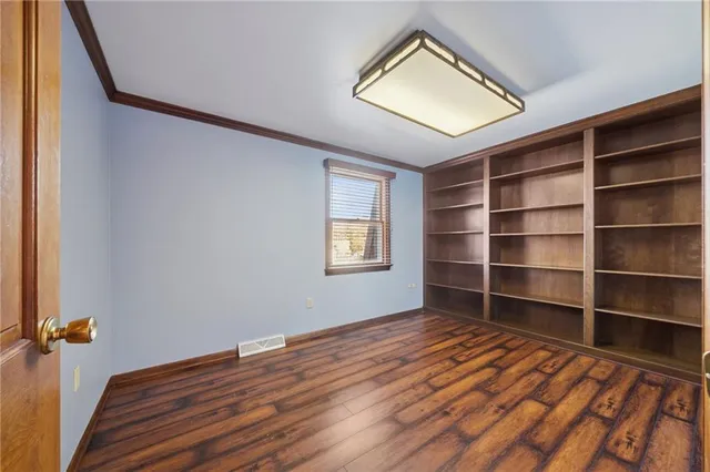 a view of a livingroom with wooden floor and a window