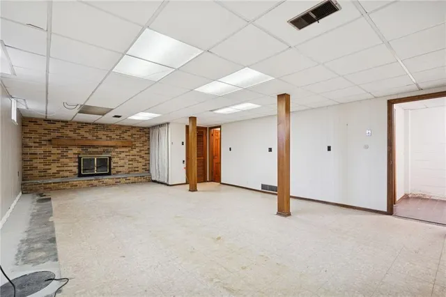 a view of empty room with fireplace