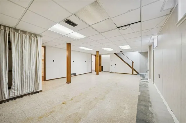 a view of empty room with wooden walls