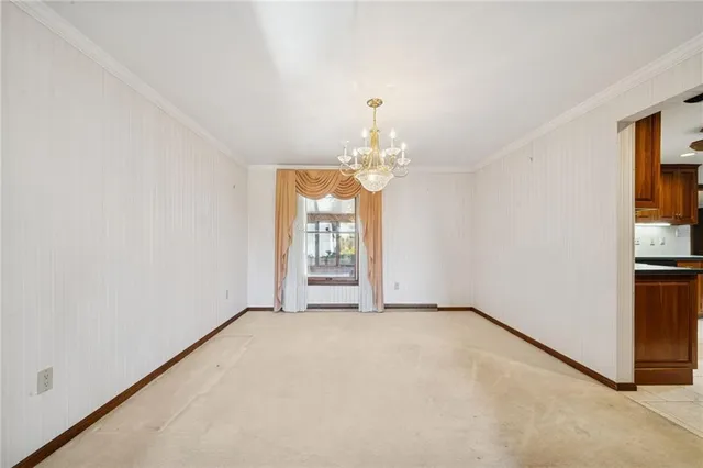 an empty room with windows and entrance