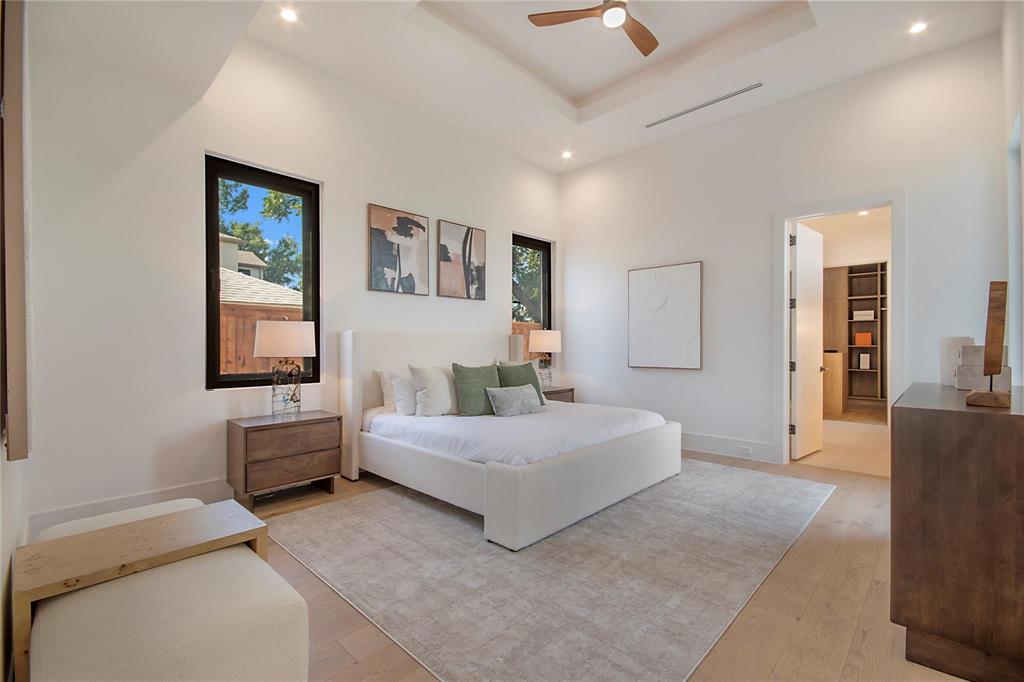 7619 Kenwell Street Dallas, TX 75209 - Photo 17 of 40 a spacious bedroom with a bed and a couch