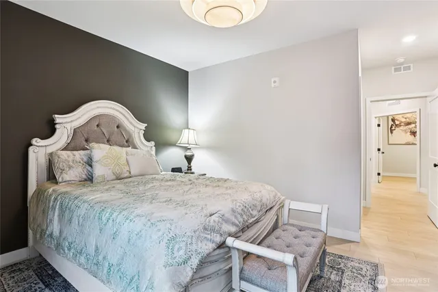 a bedroom with a bed and lamp