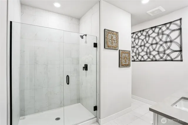 a bathroom with a shower and a sink