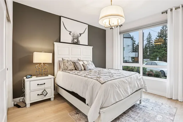 a bedroom with a large bed and a window