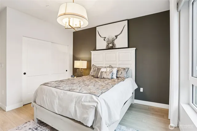 a bedroom with a bed and wooden floor