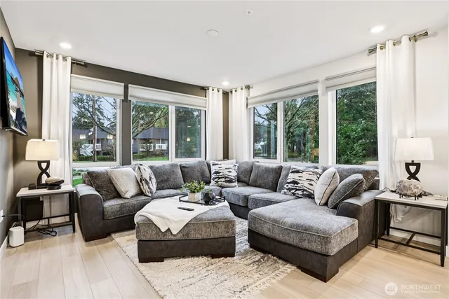 a living room with furniture and large windows